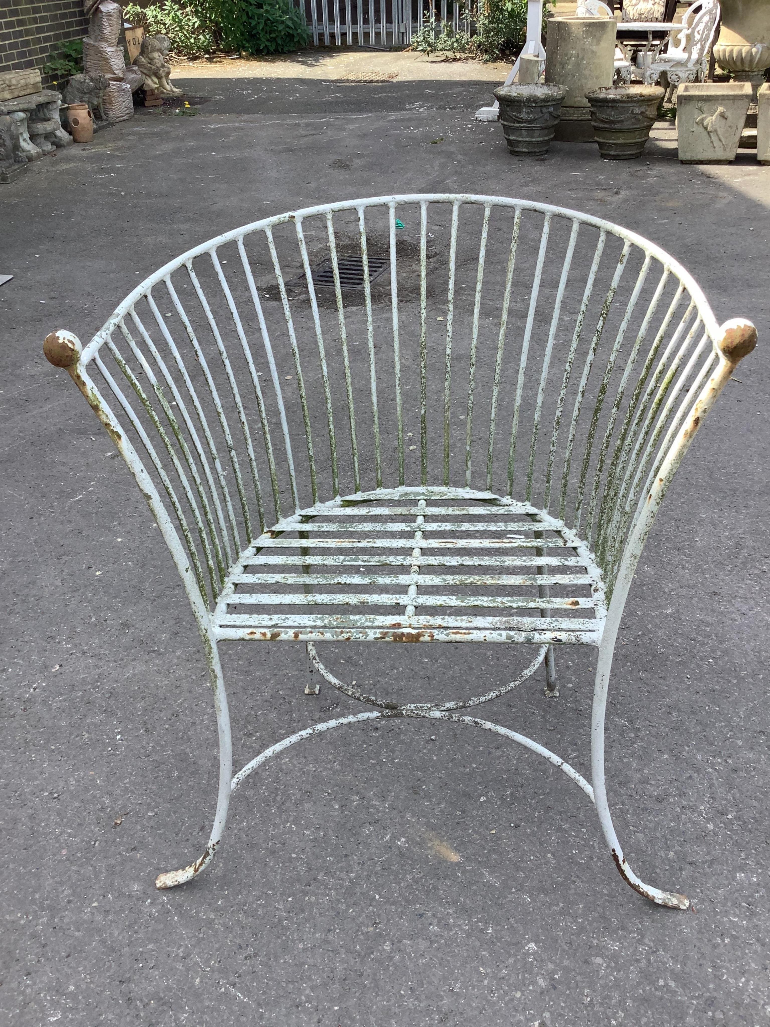 A painted wrought iron stick back garden bench, width 159cm, depth 55cm, height 91cm and a similar armchair